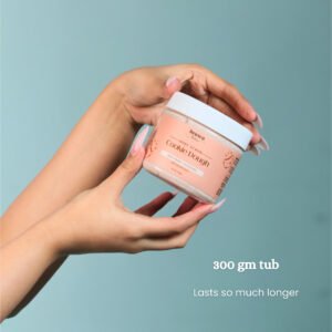 Model holding Cookie Dough chocolate body scrub open jar