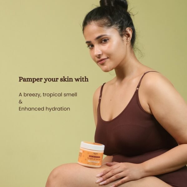 Model holding Tropical Sunset Coconut Body Butter glowing skin