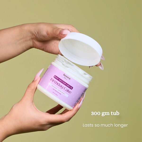 Model holding open jar of Birthday Cake Vanilla Body Butter